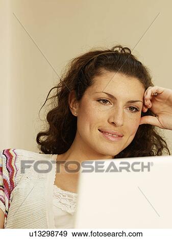 Close up of woman using laptop View Large Photo Image Stock Photo - Close up of woman using laptop. Fotosearch