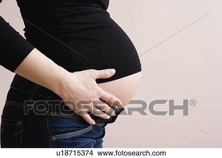 Picture - Close-up pregnant belly. Fotosearch
