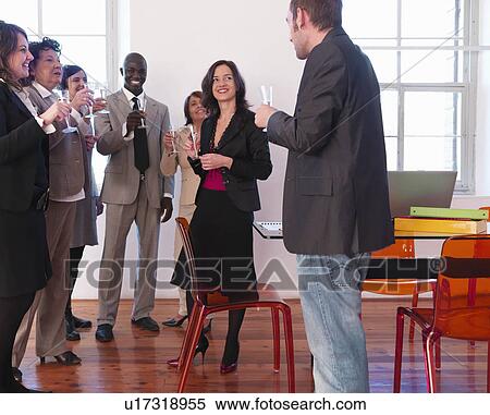 Stock Photography - Co-workers celebrating with champagne. Fotosearch