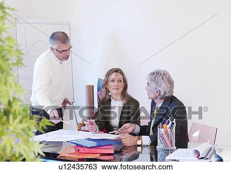 Stock Image - Co-workers in office. Fotosearch