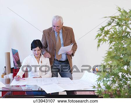 Stock Photo - Co-workers in office. Fotosearch