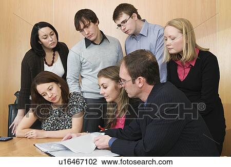 Stock Image - Colleagues looking at report. Fotosearch