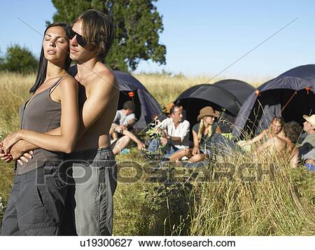 Stock Photo - "Couple at a festival, backpacking tents". Fotosearch