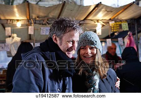 Couple at outdoor market View Large Photo Image Stock Photo - Couple at outdoor market. Fotosearch