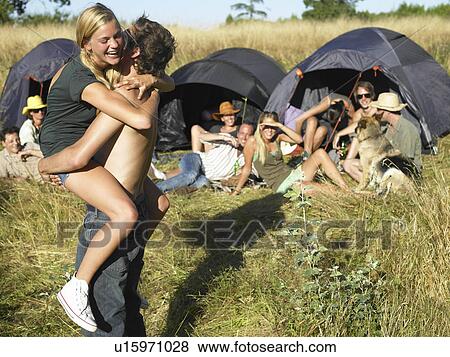 Stock Photo - "Couple dancing, backpacking tents". Fotosearch