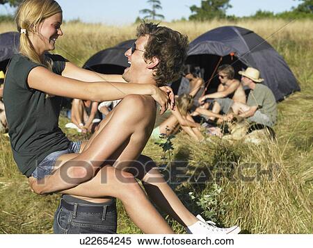 Stock Photography - "Couple dancing, backpacking tents". Fotosearch