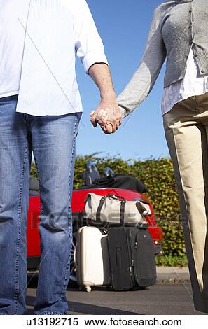 Couple holding hands by car View Large Photo Image Stock Photography - Couple holding hands by car. Fotosearch