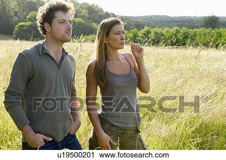 Couple in a field View Large Photo Image Stock Image - Couple in a field. Fotosearch
