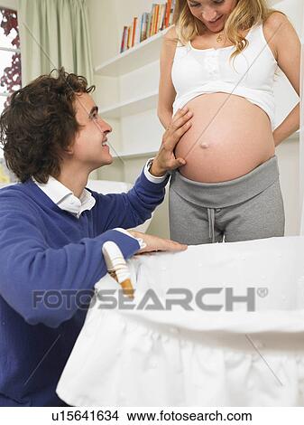 Picture - Couple in nursery. Fotosearch