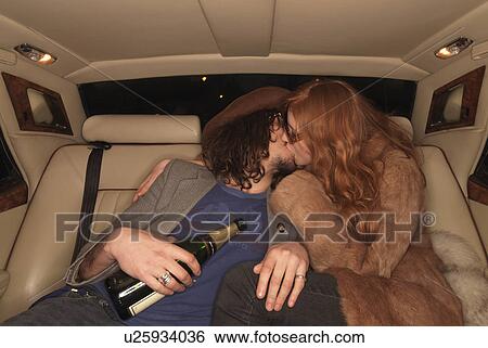 Couple kissing on backseat of luxury car View Large Photo Image Stock Photograph - Couple kissing on backseat of luxury car. Fotosearch