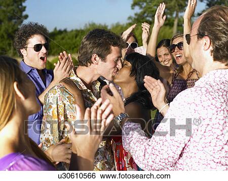 Stock Photograph - "Couple kissing, people clapping hands". Fotosearch