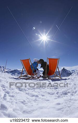 Couple kissing/reclining in deck chairs View Large Photo Image Stock Image - Couple kissing/reclining in deck chairs. Fotosearch