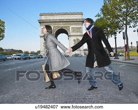 Couple walking on Champs Elysees View Large Photo Image Stock Photo - Couple walking on Champs Elysees. Fotosearch
