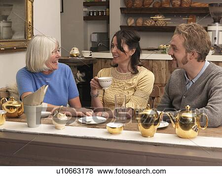 Customers having tea in café View Large Photo Image Stock Photo - Customers having tea in café. Fotosearch