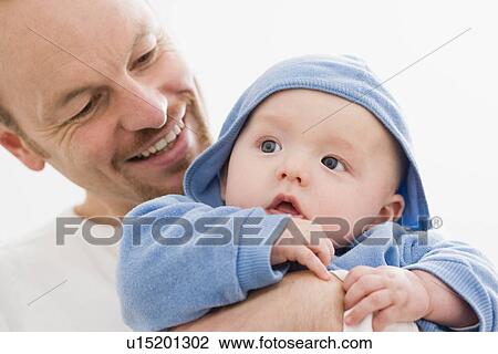 Stock Image - Dad holding his baby. Fotosearch