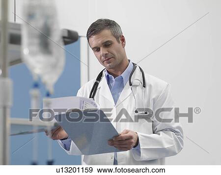 Doctor and notes in hospital environment View Large Photo Image Stock Photo - Doctor and notes in hospital environment. Fotosearch