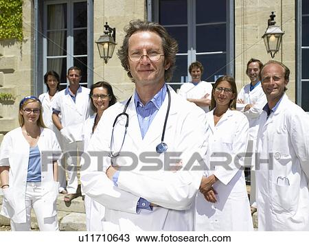 Stock Image - Doctors standing outdoors. Fotosearch
