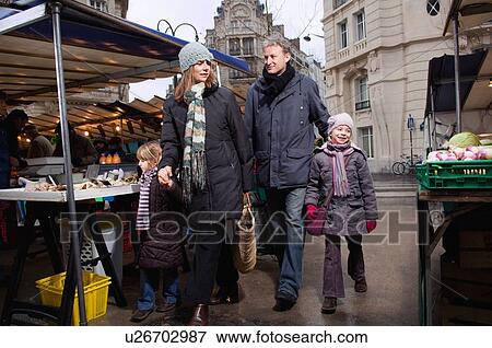 Stock Photo - Family walking in outdoor market. Fotosearch