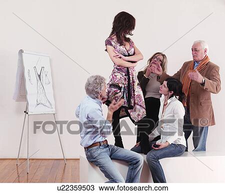 Fashion designers looking at dress View Large Photo Image Stock Image - Fashion designers looking at dress. Fotosearch
