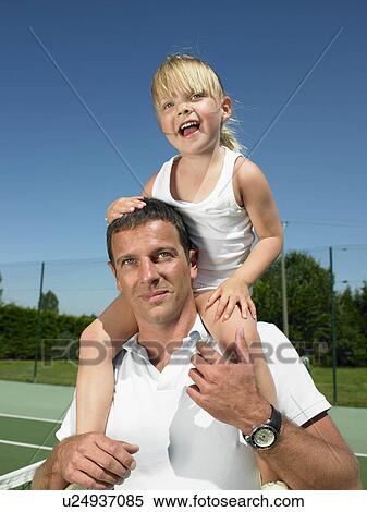 Stock Photography - Father and daughter on tennis court. Fotosearch