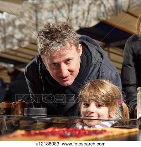"Father, daughter looking at crepe" View Large Photo Image Stock Image - "Father, daughter looking at crepe". Fotosearch