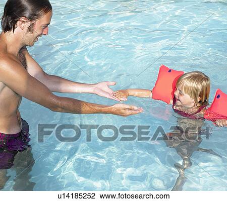 Father teaching daughter how to swim View Large Photo Image Stock Image - Father teaching daughter how to swim. Fotosearch