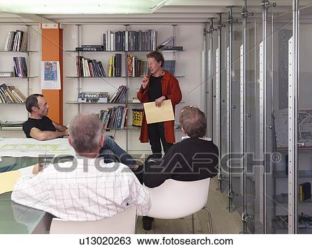 Stock Image - Female architect giving presentation. Fotosearch