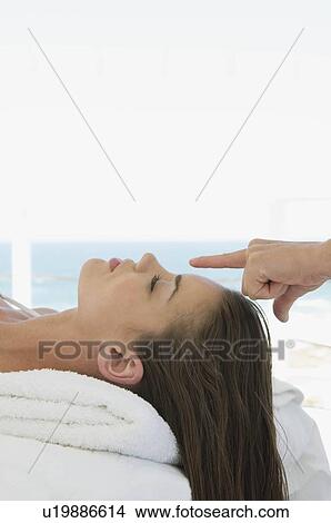 Picture - Female being given massage. Fotosearch