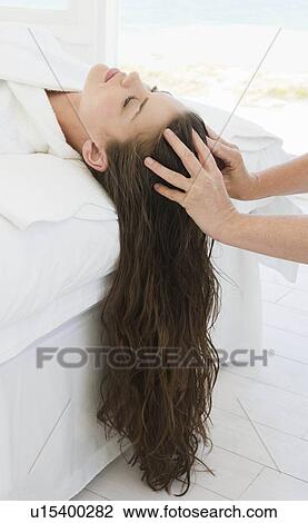 Stock Image - Female being given massage. Fotosearch