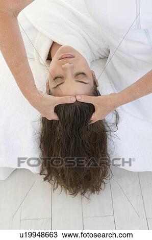 Stock Image - Female being given massage. Fotosearch