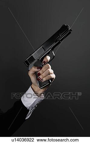 Stock Image - Female hand holding a gun. Fotosearch