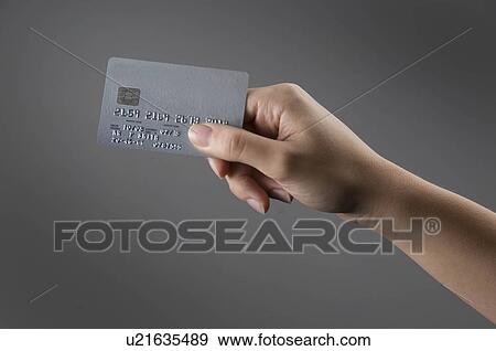 Stock Photo - Female hand holding credit card. Fotosearch