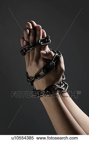 Stock Photography - Female hands chained together. Fotosearch