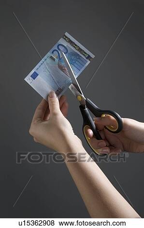 Female hands cutting a Euro note View Large Photo Image Stock Photo - Female hands cutting a Euro note. Fotosearch