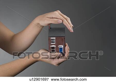 Female hands holding model house View Large Photo Image Stock Photo - Female hands holding model house. Fotosearch