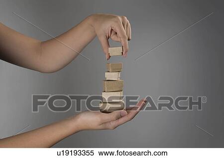 Stock Photography - Female hands holding pile of small boxes. Fotosearch