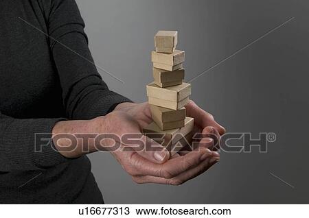 Stock Image - Female hands holding small boxes. Fotosearch