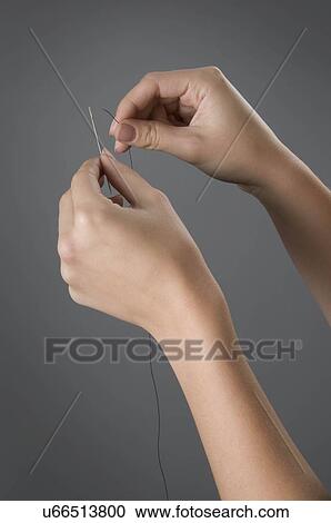 Female hands threading needle View Large Photo Image Stock Image - Female hands threading needle. Fotosearch