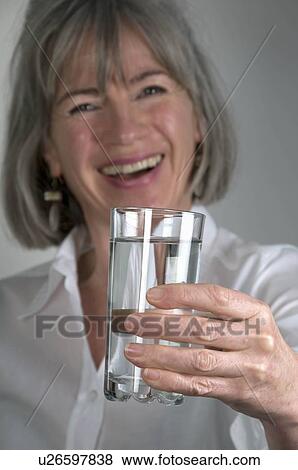 Female holding glass of water View Large Photo Image Stock Photo - Female holding glass of water. Fotosearch