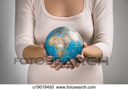 Female holding globe View Large Photo Image Stock Image - Female holding globe. Fotosearch