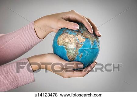 Female holding globe View Large Photo Image Stock Photo - Female holding globe. Fotosearch