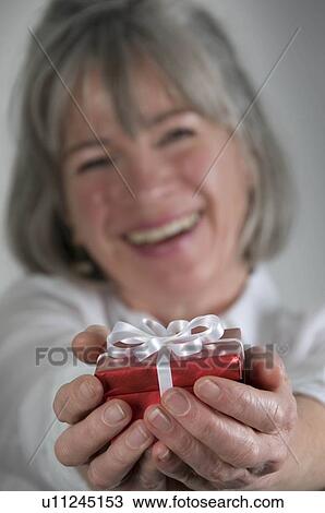 Female holding present View Large Photo Image Stock Image - Female holding present. Fotosearch