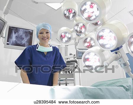 Picture - Female nurse in operating theatre. Fotosearch