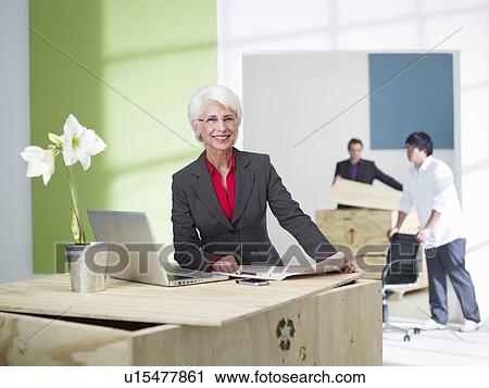 Stock Image - Female senior superior in new office. Fotosearch