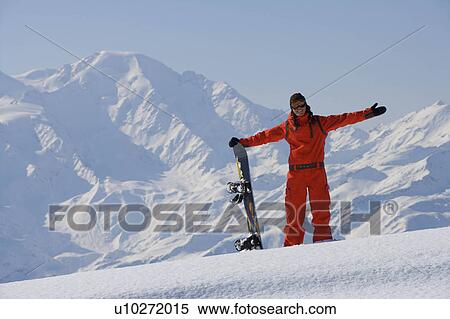 Stock Photography - Female snowboarder posing in the snow. Fotosearch