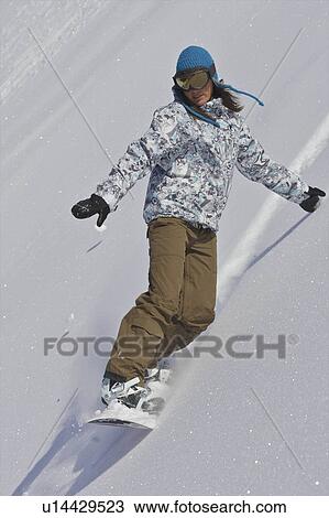 Female snowboarder turning off piste View Large Photo Image Stock Image - Female snowboarder turning off piste. Fotosearch