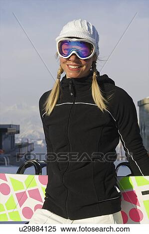 Stock Photography - Female snowboarder with her board. Fotosearch