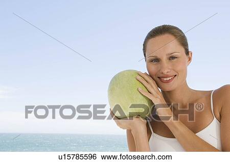 Stock Photograph - Female with fruit. Fotosearch