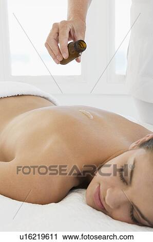 Stock Image - Female with massage oil. Fotosearch