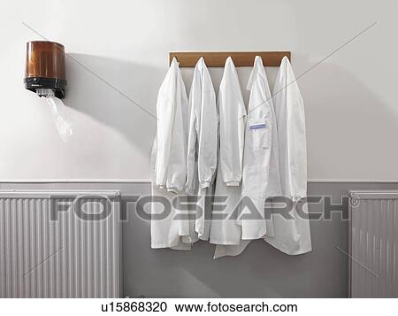 Stock Image - Five hanging laboratory coats. Fotosearch